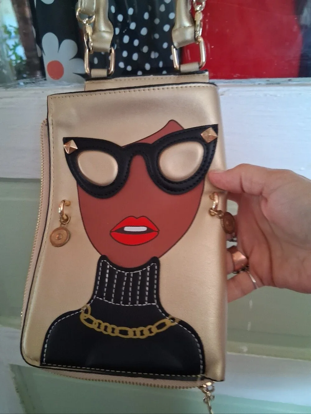 Fashionable Gold Crossbody Bag with Graphic Face Design
